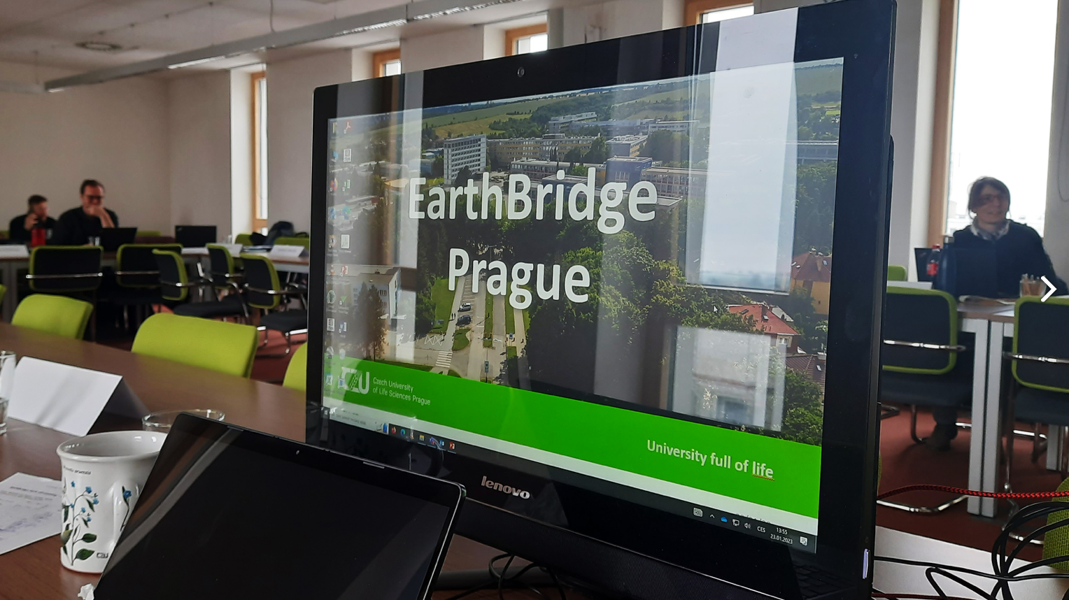 Photo of desktop PC screen with EarthBridge presentation on
